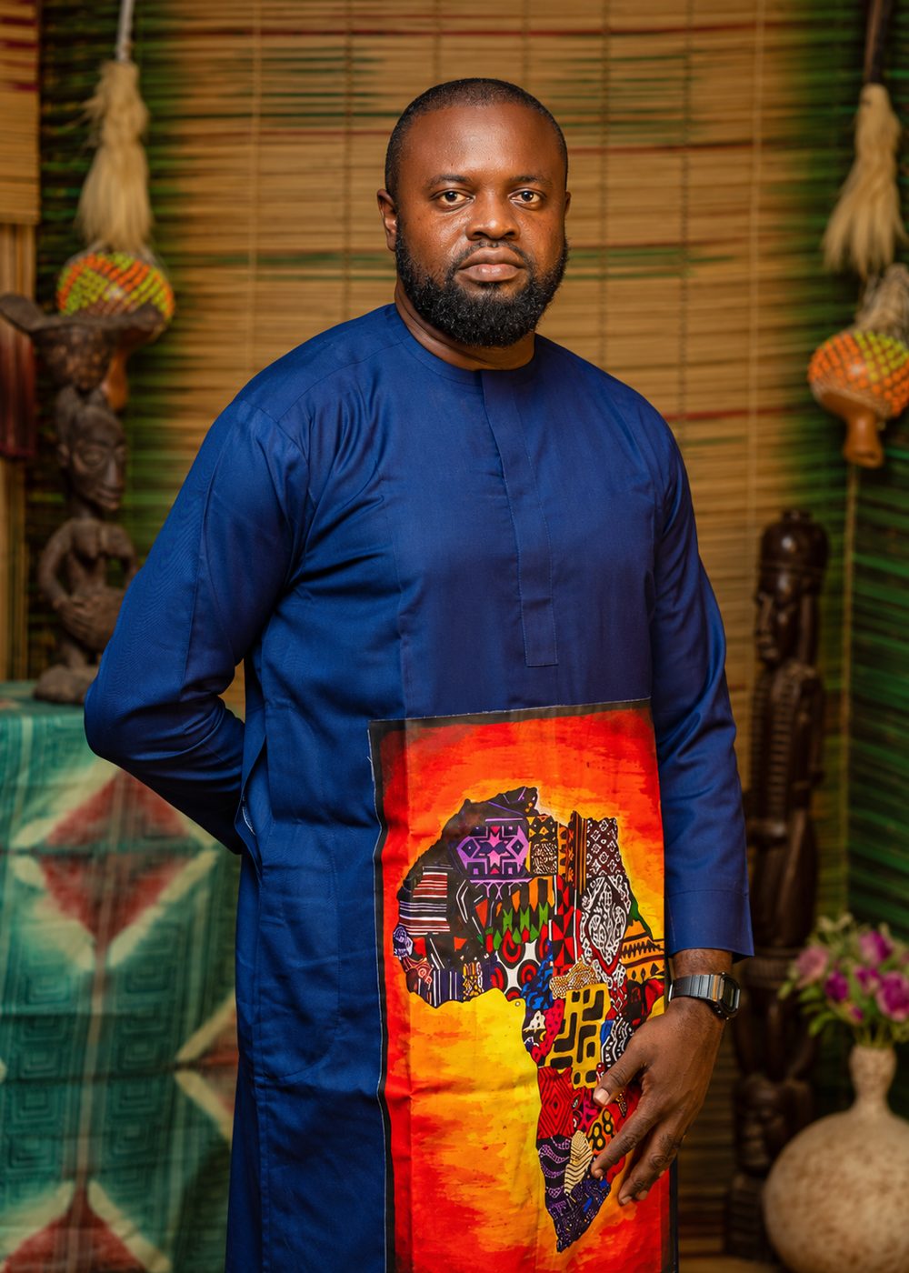 Femi Fragile in a navy kaftan with a painted map of Africa
